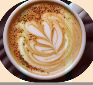 Pumpkin Spice Latte with whipped cream and cinnamon, served in a ceramic mug.